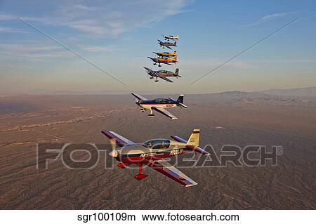 Extra 300 aerobatic aircraft fly in formation over Mesa, Arizona. View Large Photo Image Picture - Extra 300 aerobatic aircraft fly in formation over Mesa, Arizona.. Fotosearch