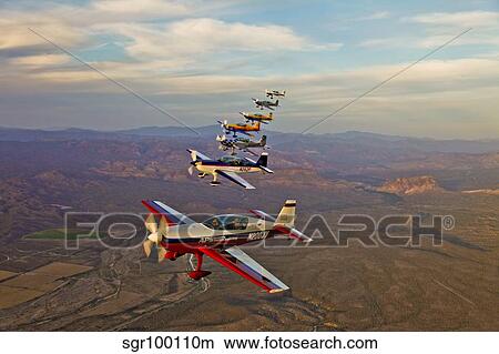 Extra 300 aerobatic aircraft fly in formation over Mesa, Arizona. View Large Photo Image Picture - Extra 300 aerobatic aircraft fly in formation over Mesa, Arizona.. Fotosearch