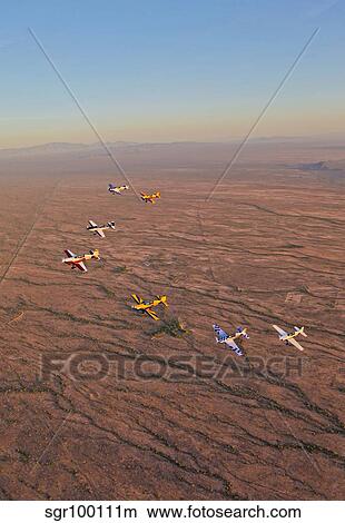 Extra 300 aerobatic aircraft fly in formation over Mesa, Arizona. View Large Photo Image Picture - Extra 300 aerobatic aircraft fly in formation over Mesa, Arizona.. Fotosearch