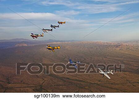 Extra 300 aerobatic aircraft fly in formation over Mesa, Arizona. View Large Photo Image Picture - Extra 300 aerobatic aircraft fly in formation over Mesa, Arizona.. Fotosearch