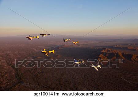 Extra 300 aerobatic aircraft fly in formation over Mesa, Arizona. View Large Photo Image Picture - Extra 300 aerobatic aircraft fly in formation over Mesa, Arizona.. Fotosearch