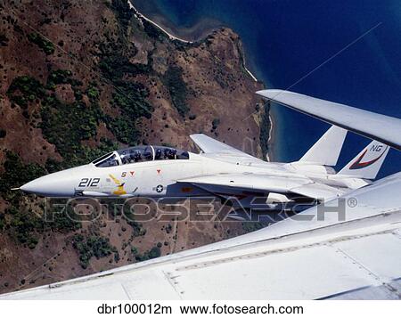 F-14 Tomcat wingman tucks into a tight formation over the Philippines. View Large Photo Image Picture - F-14 Tomcat wingman tucks into a tight formation over the Philippines.. Fotosearch