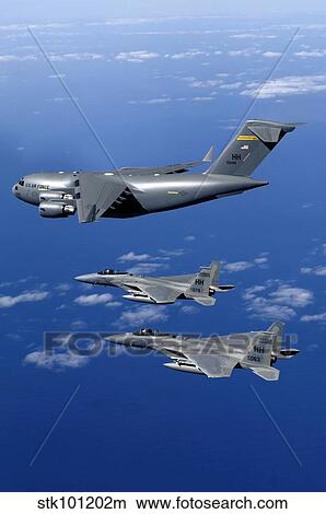 F-15B Eagles escort the first Hawaii-based C-17 Globemaster III to its home. View Large Photo Image Picture - F-15B Eagles escort the first Hawaii-based C-17 Globemaster III to its home.. Fotosearch