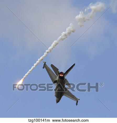 F-16AM Fighting Falcon spitting flare. View Large Photo Image Picture - F-16AM Fighting Falcon spitting flare.. Fotosearch