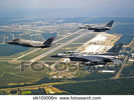 F-35 Lightning II aircraft in flight with two F-16 Fighting Falcons over Florida. View Large Photo Image Picture - F-35 Lightning II aircraft in flight with two F-16 Fighting Falcons over Florida.. Fotosearch