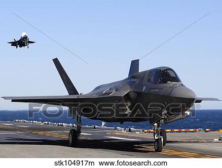 F-35B Lighnting II variants land aboard the flight deck of USS Wasp. View Large Photo Image Picture - F-35B Lighnting II variants land aboard the flight deck of USS Wasp.. Fotosearch