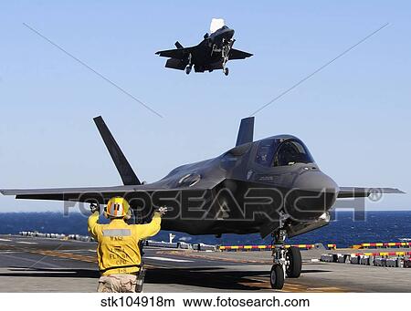 F-35B Lighnting II variants land aboard the flight deck of USS Wasp. View Large Photo Image Picture - F-35B Lighnting II variants land aboard the flight deck of USS Wasp.. Fotosearch