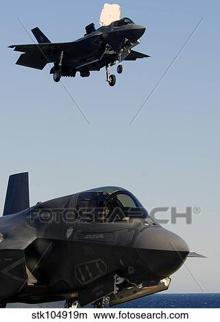 F-35B Lighnting II variants land aboard the flight deck of USS Wasp. View Large Photo Image Picture - F-35B Lighnting II variants land aboard the flight deck of USS Wasp.. Fotosearch