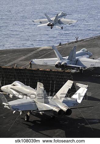 Picture - F/A-18 Hornets prepare to launch from the flight deck of USS Nimitz. . Fotosearch