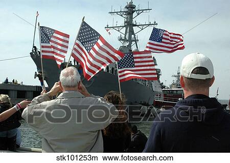 Family members wave flags to show their support. View Large Photo Image Picture - Family members wave flags to show their support.. Fotosearch