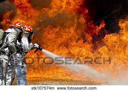 Firefighters combat a JP-8 jet fuel fire. View Large Photo Image Picture - Firefighters combat a JP-8 jet fuel fire.. Fotosearch