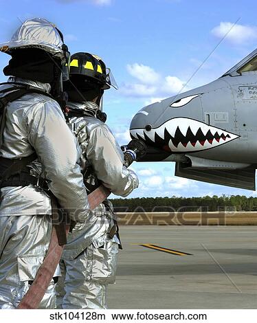 Firefighters deploy a fire hose during a drill at Moody Air Force Base. View Large Photo Image Picture - Firefighters deploy a fire hose during a drill at Moody Air Force Base.. Fotosearch