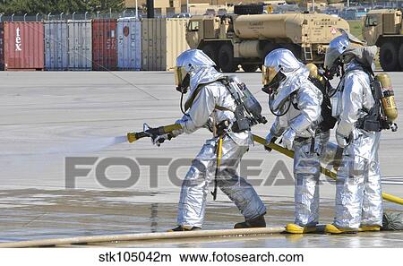 Firefighters execute fire containment procedures during a simulated emergency. View Large Photo Image Picture - Firefighters execute fire containment procedures during a simulated emergency.. Fotosearch