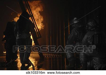 Picture - Firefighters extinguish a simulated cargo fire at RAF Mildenhall, England.. Fotosearch