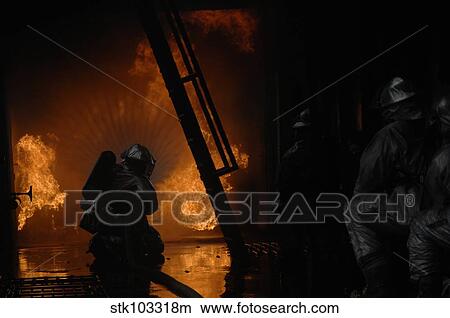 Picture - Firefighters extinguish a simulated cargo fire at RAF Mildenhall, England.. Fotosearch