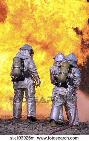 Picture - Firefighters extinguish an aircraft fire during a training exercise.. Fotosearch