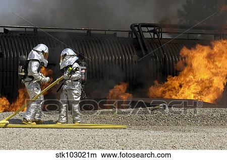 Picture - Firefighters neutralize a live fire.. Fotosearch