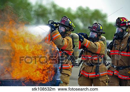 Picture - Firefighters put out a fire during at Minot Air Force Base, North Dakota. Fotosearch