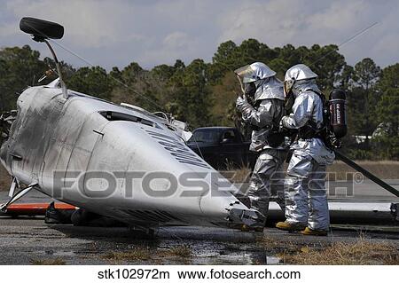 Firefighters respond to the scene of a simulated plane crash. View Large Photo Image Picture - Firefighters respond to the scene of a simulated plane crash.. Fotosearch