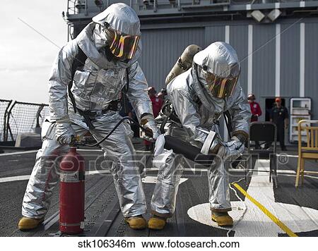 Firemen confirm a simulated fire is extinguished on the flight deck of USS Chosin. View Large Photo Image Picture - Firemen confirm a simulated fire is extinguished on the flight deck of USS Chosin.. Fotosearch