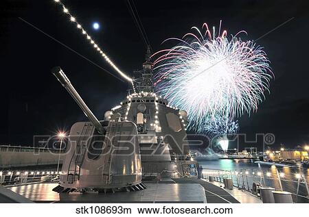 Picture - Fireworks light up the sky behind the guided missile destroyer JS Kirishima.. Fotosearch