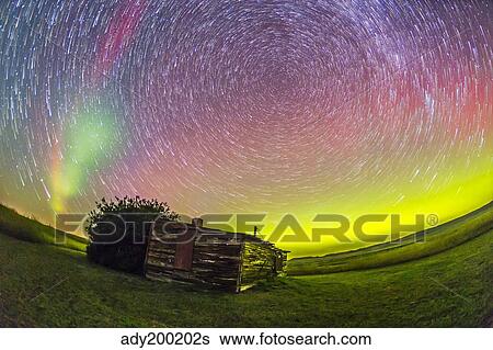 Fish-eye lens composite of aurora and circumpolar star trails above ranch in Canada. View Large Photo Image Stock Photograph - Fish-eye lens composite of aurora and circumpolar star trails above ranch in Canada.. Fotosearch
