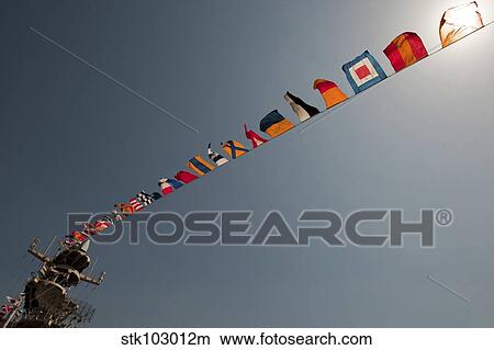 Flags fly over the deck of the USS Iwo Jima. View Large Photo Image Picture - Flags fly over the deck of the USS Iwo Jima.. Fotosearch