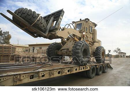 forklift is unloaded off of a logistics support vehicle. View Large Photo Image Picture - forklift is unloaded off of a logistics support vehicle.. Fotosearch
