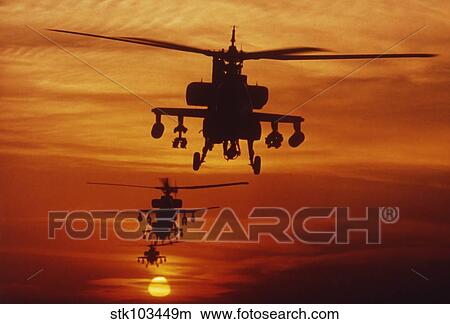 Four AH-64 Apache anti-armor helicopters fly in formation at dusk. View Large Photo Image Picture - Four AH-64 Apache anti-armor helicopters fly in formation at dusk.. Fotosearch