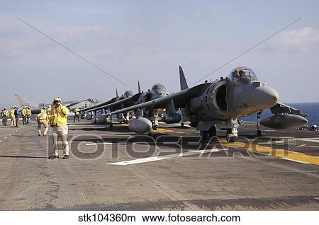 Four AV-8B Harrier jets line up for take-off aboard USS Essex. View Large Photo Image Picture - Four AV-8B Harrier jets line up for take-off aboard USS Essex.. Fotosearch