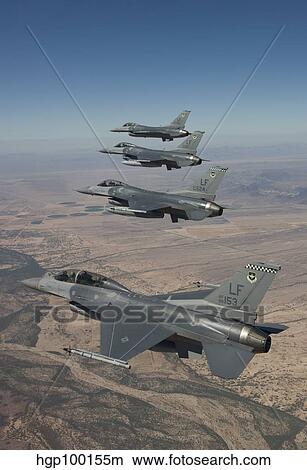 Picture - Four F-16's maneuver on a training mission over the Arizona desert.. Fotosearch