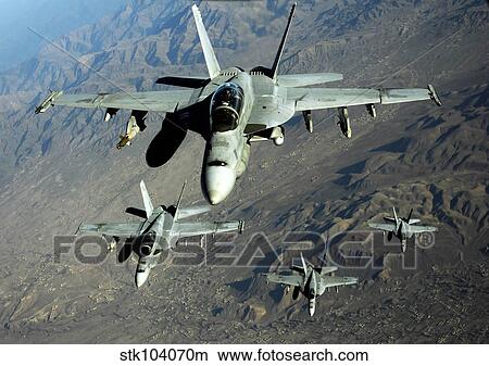 Four U. S. Navy F/A-18 Hornet aircraft fly over mountains in Afghanistan. View Large Photo Image Picture - Four U. S. Navy F/A-18 Hornet aircraft fly over mountains in Afghanistan.. Fotosearch