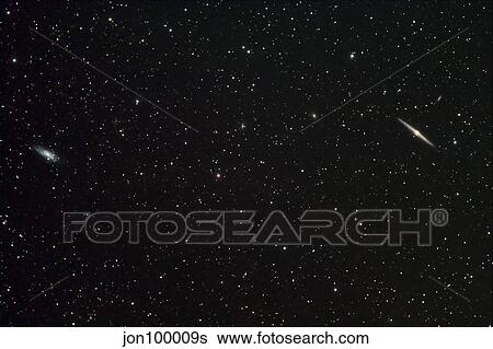 Galaxies NGC 4559 and NGC 4565. View Large Photo Image Stock Photograph - Galaxies NGC 4559 and NGC 4565.. Fotosearch