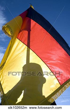 German Air Force Airman holds the German flag. View Large Photo Image Picture - German Air Force Airman holds the German flag.. Fotosearch