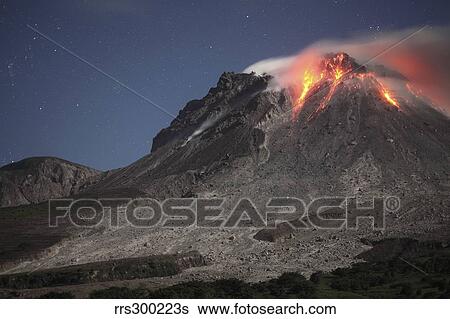 Stock Photograph - Glowing lava dome during eruption of Soufriere Hills volcano, Montserrat, Caribbean.. Fotosearch