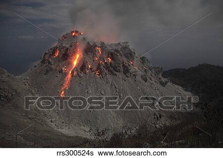 Stock Photograph - Glowing Rerombola lava dome of Paluweh volcano, Indonesia.. Fotosearch