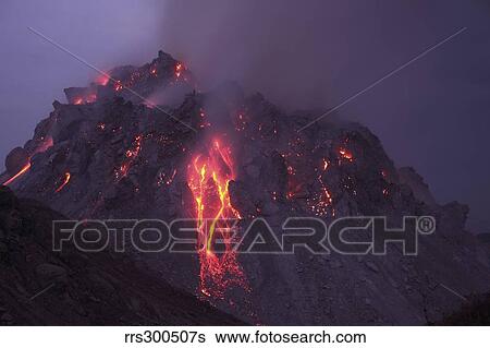 Stock Photograph - Glowing Rerombola lava dome with incandescent rockfall deposit.. Fotosearch