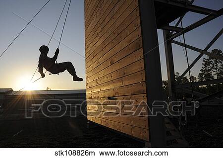 Green Beret rappels down a 50 foot wall. View Large Photo Image Picture - Green Beret rappels down a 50 foot wall.. Fotosearch