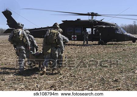 Green Berets move a simulated casualty to a UH-60 helicopter for transport. View Large Photo Image Picture - Green Berets move a simulated casualty to a UH-60 helicopter for transport.. Fotosearch