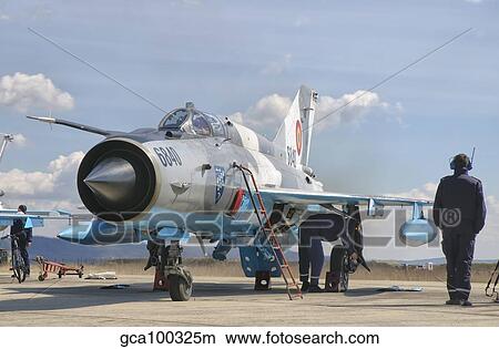 Ground crew conducts maintenance on a Romanian Air Force MiG-21C. View Large Photo Image Picture - Ground crew conducts maintenance on a Romanian Air Force MiG-21C.. Fotosearch