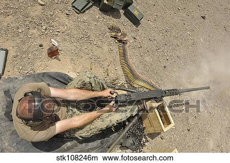 Gunner's Mate fires an M2. 50-caliber machine gun. View Large Photo Image Picture - Gunner's Mate fires an M2. 50-caliber machine gun.. Fotosearch
