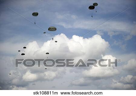 HALO jumpers descend to the ground after exiting a C-17 Globemaster III. View Large Photo Image Picture - HALO jumpers descend to the ground after exiting a C-17 Globemaster III.. Fotosearch