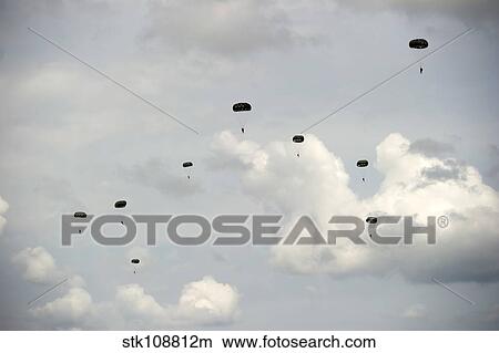 HALO jumpers descend to the ground after exiting a C-17 Globemaster III. View Large Photo Image Picture - HALO jumpers descend to the ground after exiting a C-17 Globemaster III.. Fotosearch
