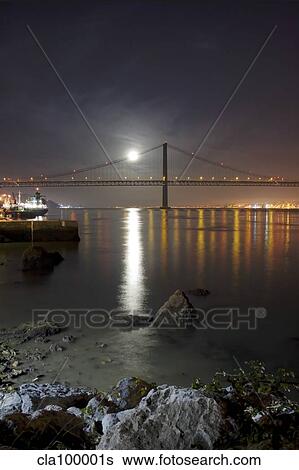 Harvest moon sets over the Tagus river and the city of Lisbon, Portugal. View Large Photo Image Stock Photograph - Harvest moon sets over the Tagus river and the city of Lisbon, Portugal.. Fotosearch