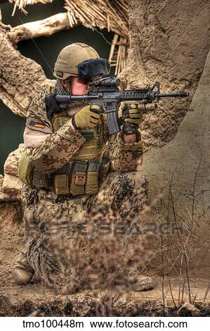 HDR image of a German Army soldier armed with a M4 carbine. View Large Photo Image Picture - HDR image of a German Army soldier armed with a M4 carbine.. Fotosearch