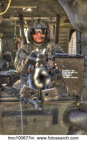 HDR image of a UH-60 Black Hawk door gunner manning a M240 machine gun. View Large Photo Image Picture - HDR image of a UH-60 Black Hawk door gunner manning a M240 machine gun.. Fotosearch