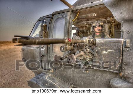 HDR image of a UH-60 Black Hawk door gunner manning a M240 machine gun. View Large Photo Image Picture - HDR image of a UH-60 Black Hawk door gunner manning a M240 machine gun.. Fotosearch