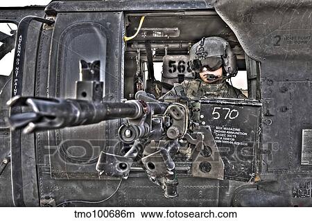 HDR image of a UH-60 Black Hawk door gunner manning a M240 machine gun. View Large Photo Image Picture - HDR image of a UH-60 Black Hawk door gunner manning a M240 machine gun.. Fotosearch