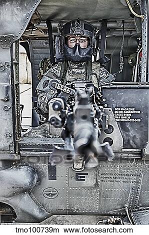 HDR image of a UH-60 Black Hawk door gunner manning a M240 machine gun. View Large Photo Image Picture - HDR image of a UH-60 Black Hawk door gunner manning a M240 machine gun.. Fotosearch