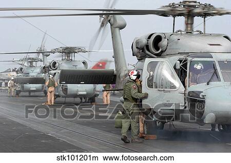 Helicopter crews change out on the flight deck aboard USS Theodore Roosevelt. View Large Photo Image Picture - Helicopter crews change out on the flight deck aboard USS Theodore Roosevelt.. Fotosearch